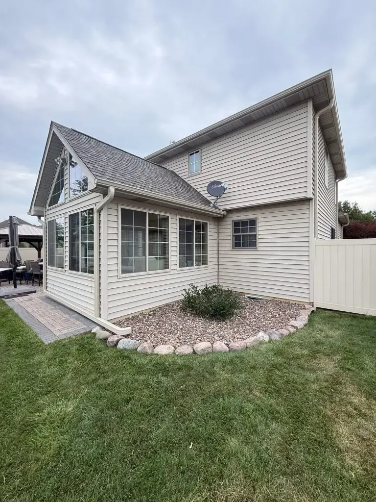 Completed beige siding and sunroom on a Schererville, Indiana home