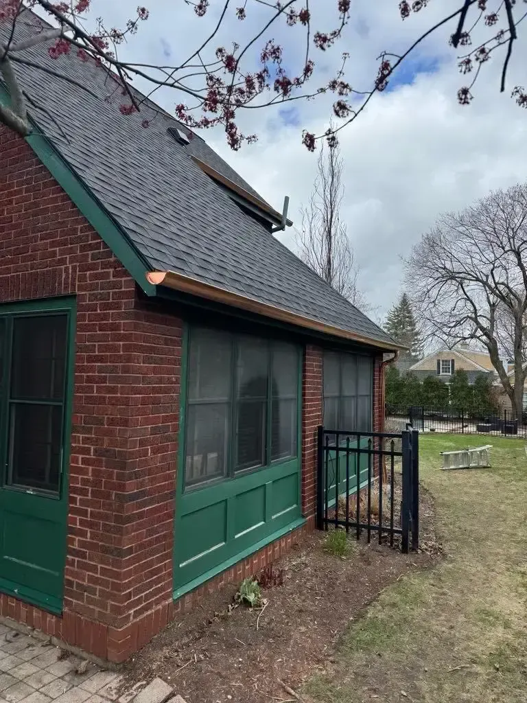 Custom half round copper gutters and twisted downspouts — Chicago, IL — photo 1