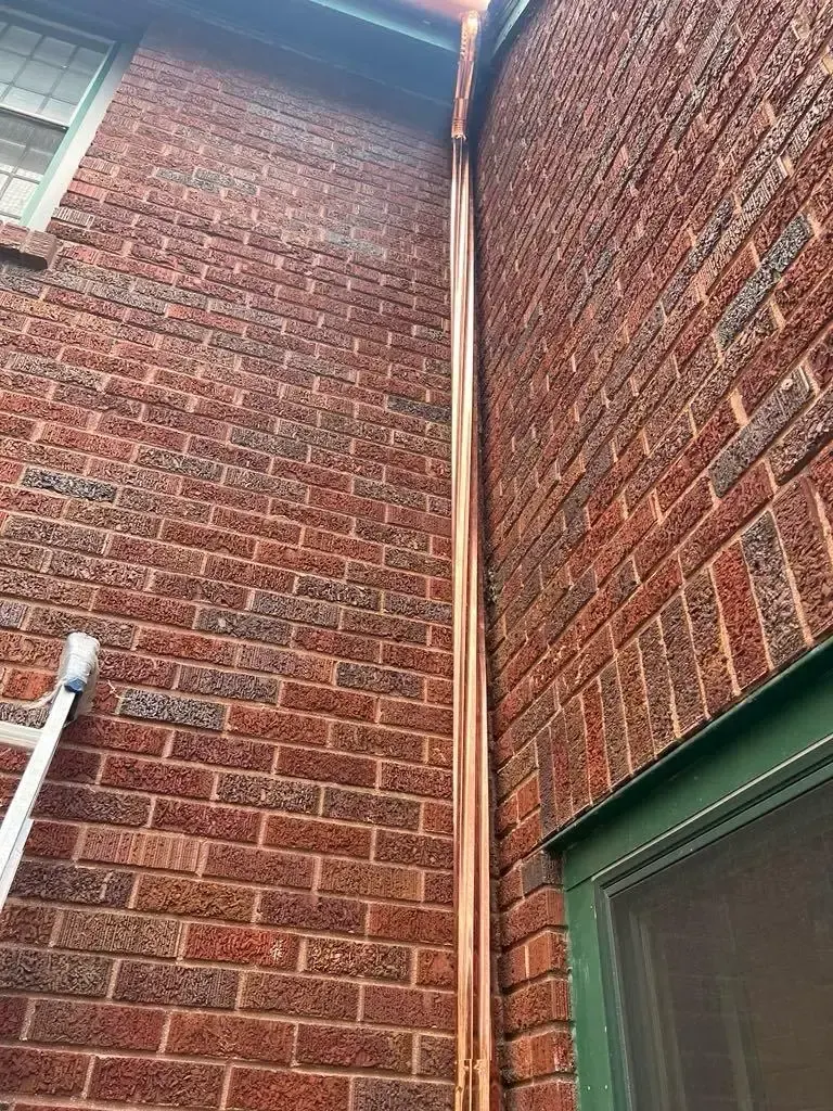 Custom half round copper gutters and twisted downspouts in Chicago