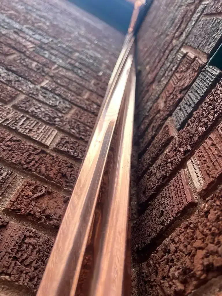 Custom half round copper gutters and twisted downspouts — Chicago, IL — photo 9