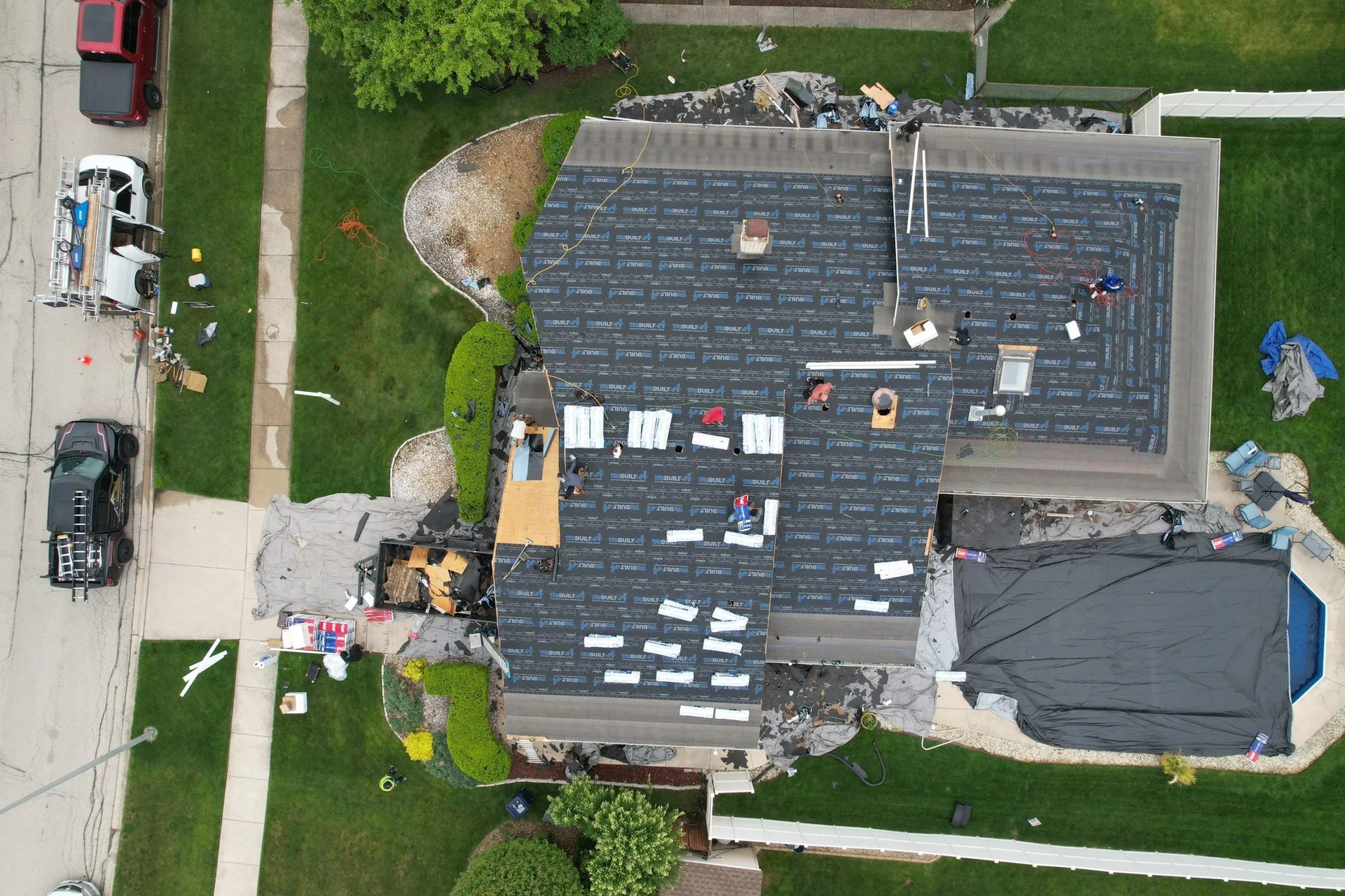 Optimal crew installing roof underlayment during a replacement in Orland Park, Illinois